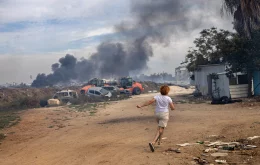 Evgenia Simanovich runs to the family home’s reinforced concrete shelter, moments after rocket sirens sounded in Ashkelon, Israel on Saturday, Oct. 7, 2023. (Tamir Kalifa/The New York Times)